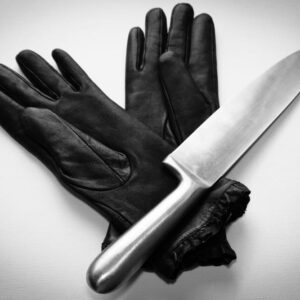 overhead-shot-metal-knife-black-gloves-white-surface